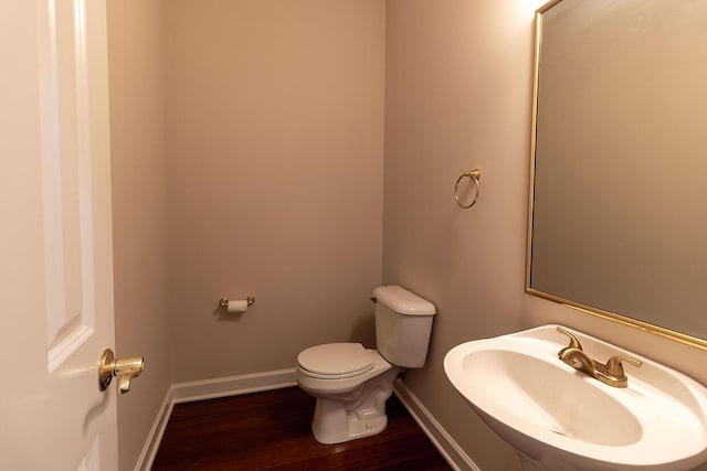 2409 Wild Oak Ct, Columbia, MO 65201 - half bathroom featuring a sink and wood finished floors