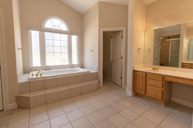 2409 Wild Oak Ct, Columbia, MO 65201 - full bath with vanity, a garden tub, plenty of natural light, tile patterned floors, and vaulted ceiling