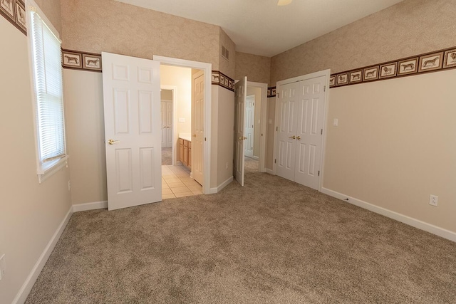 2409 Wild Oak Ct, Columbia, MO 65201 - unfurnished bedroom featuring light colored carpet and connected bathroom
