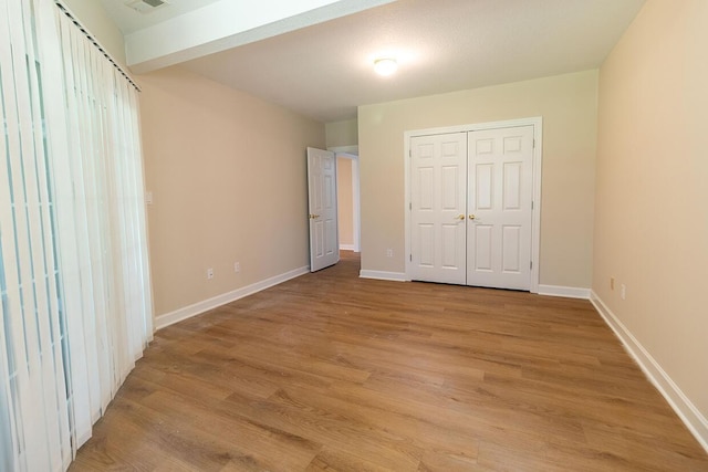 2409 Wild Oak Ct, Columbia, MO 65201 - unfurnished bedroom with light wood finished floors and a closet