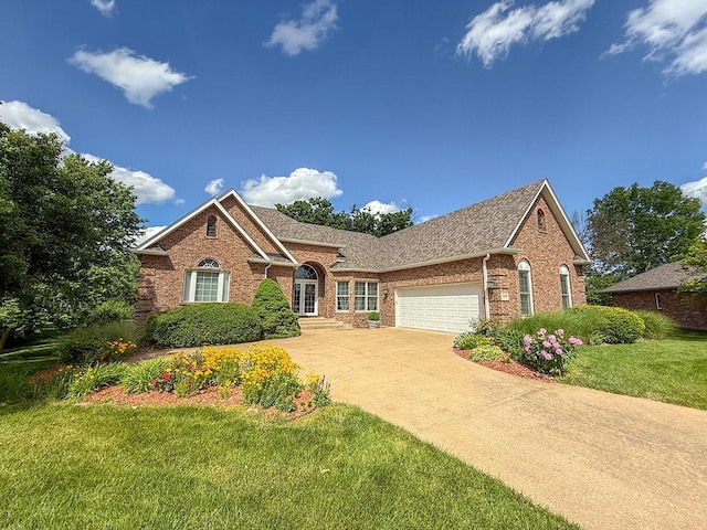 2409 Wild Oak Ct, Columbia, MO 65201 - view of front of house with brick siding, an attached garage, a front yard, concrete driveway, and roof with shingles
