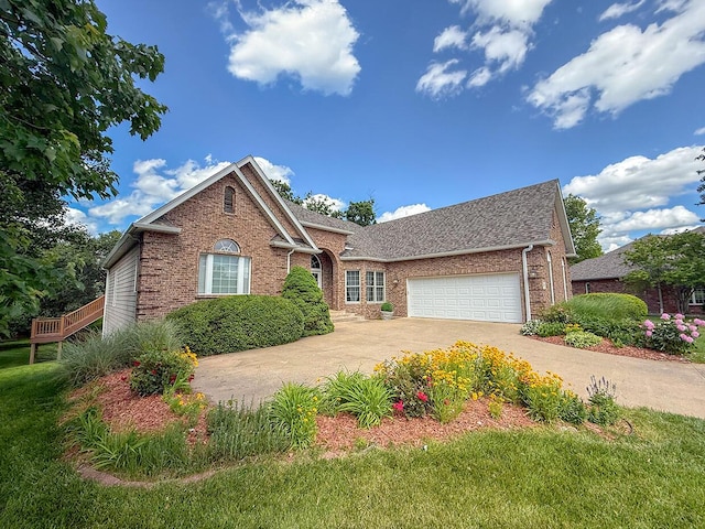 2409 Wild Oak Ct, Columbia, MO 65201 - view of front of property with brick siding, a garage, concrete driveway, roof with shingles, and a front lawn
