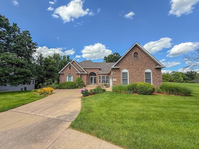 2409 Wild Oak Ct, Columbia, MO 65201 - view of front facade featuring brick siding, a front yard, driveway, and a shingled roof