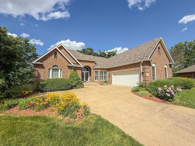 2409 Wild Oak Ct, Columbia, MO 65201 - view of front facade with brick siding, a garage, concrete driveway, and a shingled roof