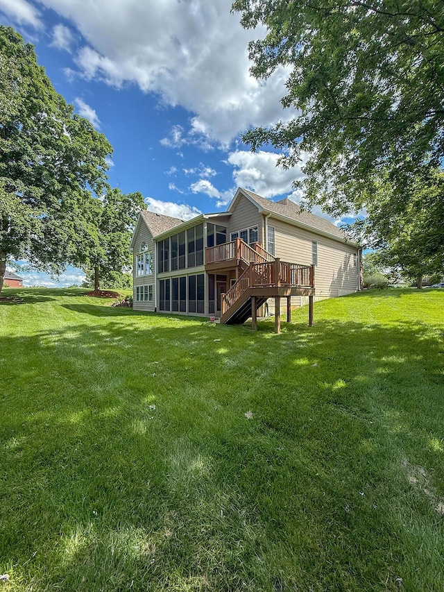 2409 Wild Oak Ct, Columbia, MO 65201 - rear view of house with a sunroom, a lawn, a deck, and stairs