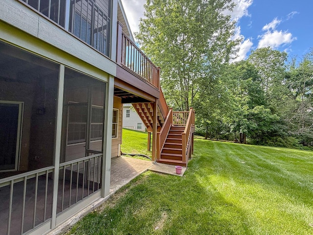 2409 Wild Oak Ct, Columbia, MO 65201 - view of grassy yard with stairs, a wooden deck, and a sunroom