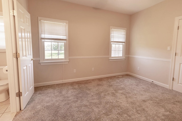 2409 Wild Oak Ct, Columbia, MO 65201 - unfurnished bedroom with multiple windows and light carpet