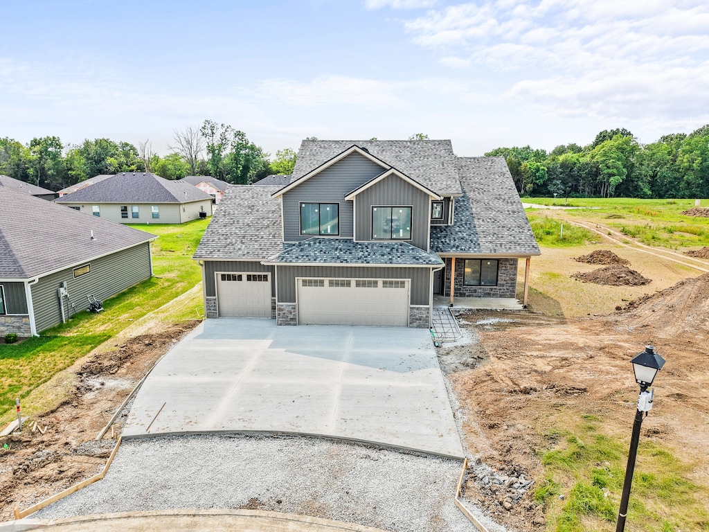 3321 Gray Birch Dr, Columbia, MO 65202 - view of front of home with stone siding, board and batten siding, concrete driveway, and a garage