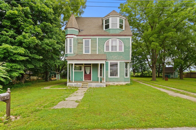 408 Vassar St, Bunceton, MO 65237 - victorian-style house featuring a porch, a front yard, and a shingled roof