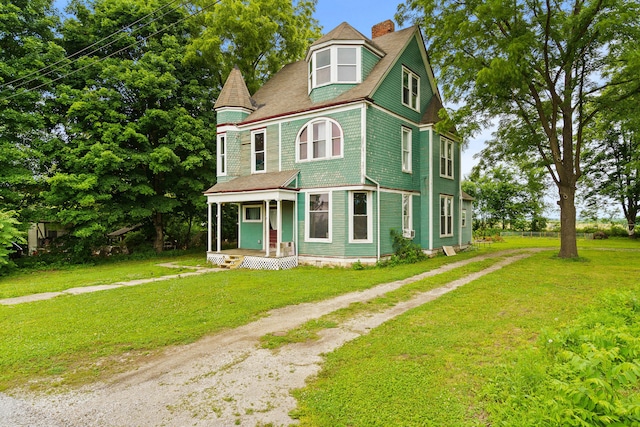408 Vassar St, Bunceton, MO 65237 - victorian home featuring a front yard, a chimney, and driveway