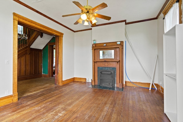 408 Vassar St, Bunceton, MO 65237 - unfurnished living room featuring wood-type flooring, ceiling fan, and crown molding