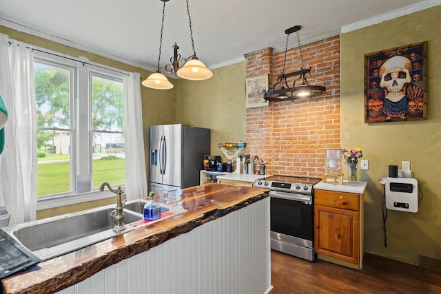 408 Vassar St, Bunceton, MO 65237 - kitchen featuring stainless steel appliances, brown cabinetry, dark wood finished floors, crown molding, and pendant lighting