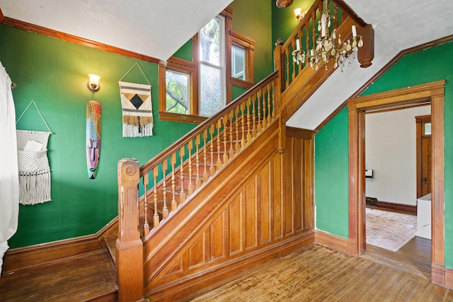 408 Vassar St, Bunceton, MO 65237 - staircase featuring hardwood / wood-style floors and crown molding