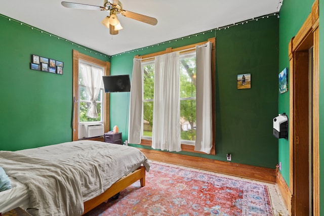 408 Vassar St, Bunceton, MO 65237 - bedroom featuring wood finished floors, cooling unit, and a ceiling fan