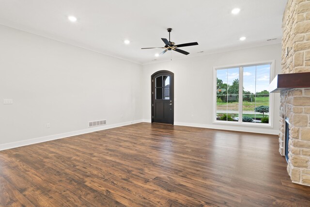 6505 Cromford Ln, Columbia, MO 65201 - unfurnished living room with dark wood-type flooring, ceiling fan, arched walkways, recessed lighting, and baseboards