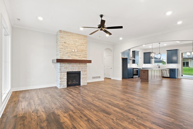 6505 Cromford Ln, Columbia, MO 65201 - unfurnished living room featuring ceiling fan, a sink, dark wood-type flooring, a stone fireplace, and crown molding
