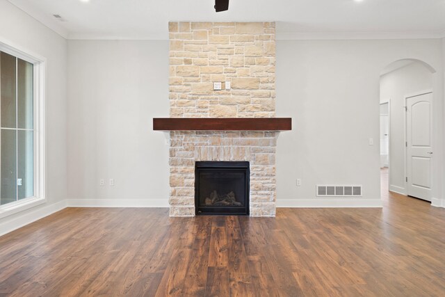 6505 Cromford Ln, Columbia, MO 65201 - unfurnished living room featuring ornamental molding, wood finished floors, a fireplace, baseboards, and arched walkways