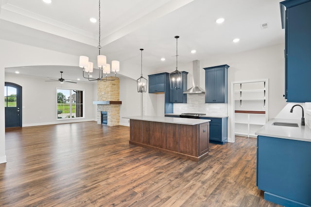 6505 Cromford Ln, Columbia, MO 65201 - kitchen with a sink, wall chimney exhaust hood, blue cabinetry, dark wood-style floors, and recessed lighting