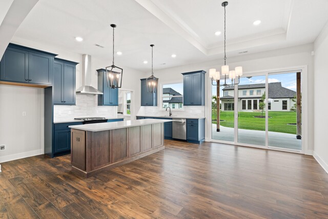 6505 Cromford Ln, Columbia, MO 65201 - kitchen featuring wall chimney range hood, appliances with stainless steel finishes, a chandelier, a sink, and a tray ceiling