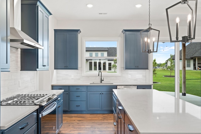 6505 Cromford Ln, Columbia, MO 65201 - kitchen with wall chimney range hood, stainless steel range with gas cooktop, a sink, a chandelier, and light countertops