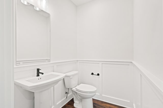 6505 Cromford Ln, Columbia, MO 65201 - half bath with wood finished floors, wainscoting, toilet, and a decorative wall