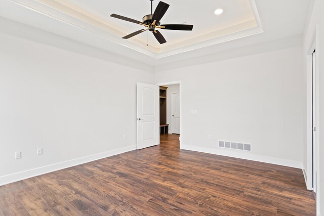 6505 Cromford Ln, Columbia, MO 65201 - spare room with a tray ceiling, dark wood finished floors, a ceiling fan, baseboards, and recessed lighting