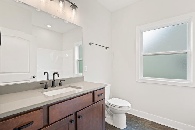 6505 Cromford Ln, Columbia, MO 65201 - full bath with vanity, toilet, baseboards, and plenty of natural light