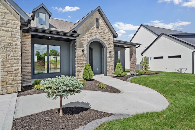 6505 Cromford Ln, Columbia, MO 65201 - view of front facade featuring a front yard, stone siding, and roof with shingles