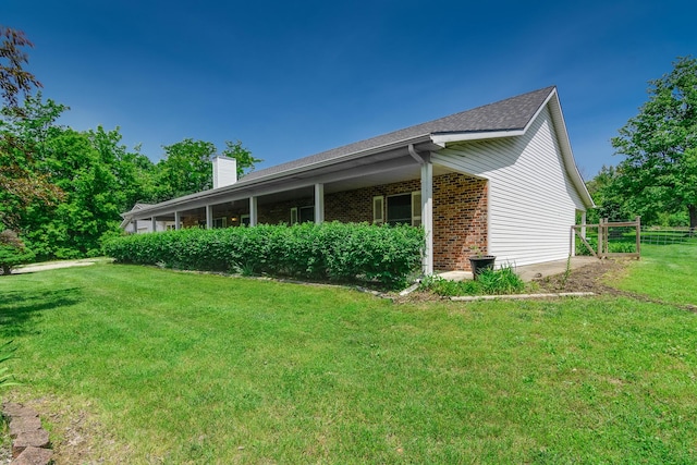 3111 E E W Snowy Hills Ln, Hartsburg, MO 65039 - view of side of home with a yard, brick siding, and a chimney