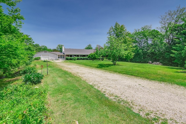 3111 E E W Snowy Hills Ln, Hartsburg, MO 65039 - ranch-style house with driveway, a front lawn, a chimney, and a garage