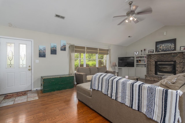 3111 E E W Snowy Hills Ln, Hartsburg, MO 65039 - living room featuring vaulted ceiling, ceiling fan, wood finished floors, and a brick fireplace