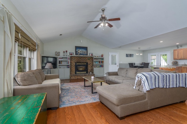 3111 E E W Snowy Hills Ln, Hartsburg, MO 65039 - living area with vaulted ceiling, light wood finished floors, a ceiling fan, a brick fireplace, and recessed lighting