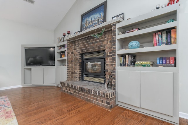 3111 E E W Snowy Hills Ln, Hartsburg, MO 65039 - living room featuring wood finished floors, vaulted ceiling, baseboards, and a fireplace