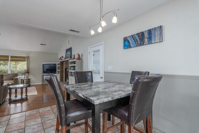3111 E E W Snowy Hills Ln, Hartsburg, MO 65039 - dining space with wainscoting, lofted ceiling, and wood finished floors