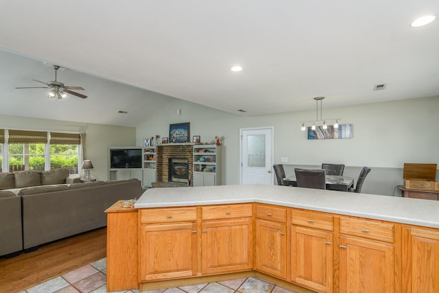 3111 E E W Snowy Hills Ln, Hartsburg, MO 65039 - kitchen featuring vaulted ceiling, light countertops, ceiling fan, open floor plan, and a fireplace