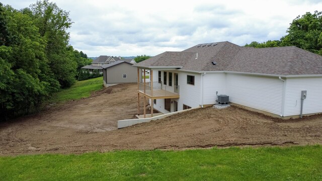 4000 S Felicity Ln, Columbia, MO 65203 - back of house with central AC unit, a shingled roof, and driveway