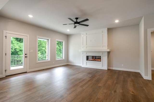 4000 S Felicity Ln, Columbia, MO 65203 - unfurnished living room with ceiling fan, a large fireplace, dark wood-style flooring, recessed lighting, and baseboards