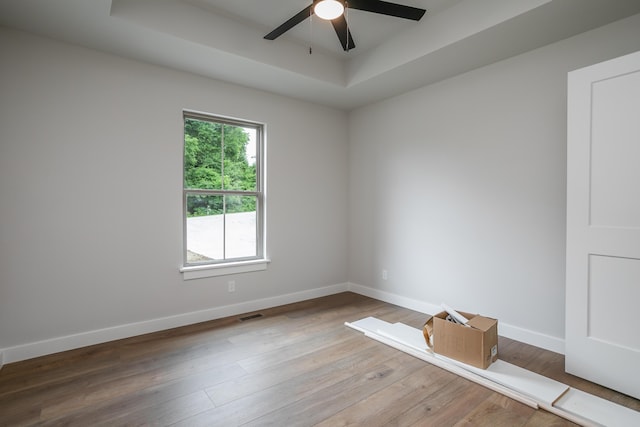 4000 S Felicity Ln, Columbia, MO 65203 - empty room with a tray ceiling, a ceiling fan, baseboards, and wood finished floors
