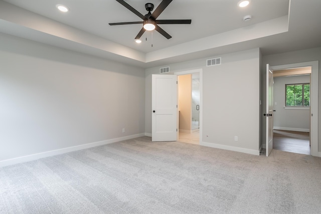 4000 S Felicity Ln, Columbia, MO 65203 - unfurnished bedroom featuring a tray ceiling, recessed lighting, light carpet, baseboards, and ensuite bath