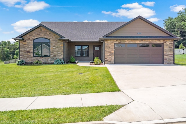 5990 W Tamarack Dr, Columbia, MO 65203 - view of front of house with stone siding, driveway, an attached garage, and roof with shingles