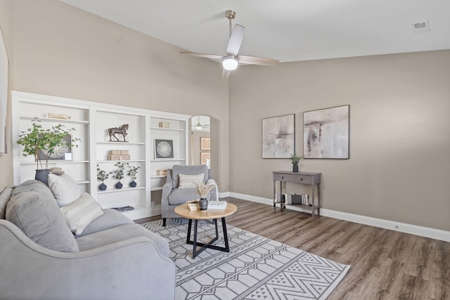 5990 W Tamarack Dr, Columbia, MO 65203 - living area featuring ceiling fan, wood finished floors, arched walkways, and high vaulted ceiling