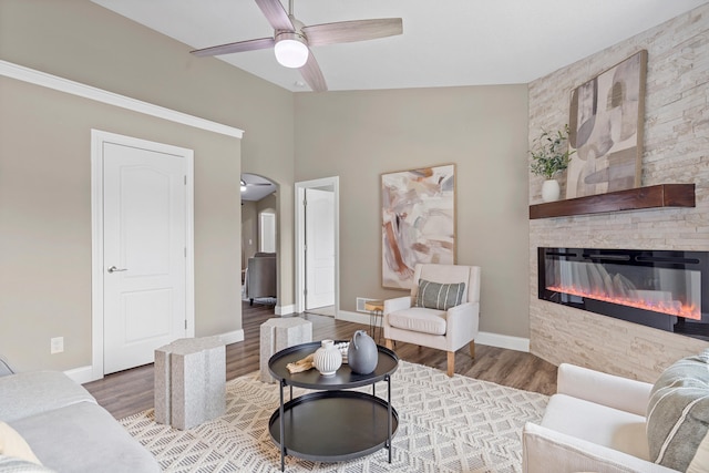 5990 W Tamarack Dr, Columbia, MO 65203 - living area featuring wood finished floors, a stone fireplace, ceiling fan, and lofted ceiling