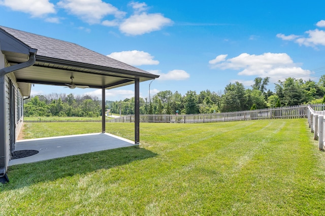 5990 W Tamarack Dr, Columbia, MO 65203 - fenced backyard featuring a ceiling fan, a patio area, and view of scattered trees
