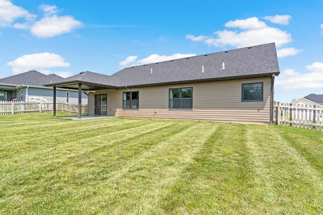 5990 W Tamarack Dr, Columbia, MO 65203 - back of property featuring a patio, a fenced backyard, and a shingled roof