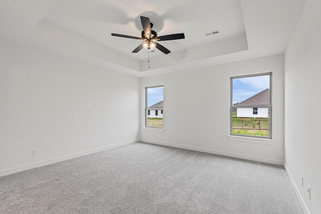 2360 N Federal Dr, Columbia, MO 65202 - carpeted empty room featuring a raised ceiling, plenty of natural light, and baseboards