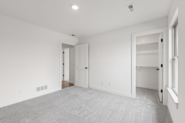 2360 N Federal Dr, Columbia, MO 65202 - unfurnished bedroom with carpet flooring, a spacious closet, baseboards, recessed lighting, and a closet