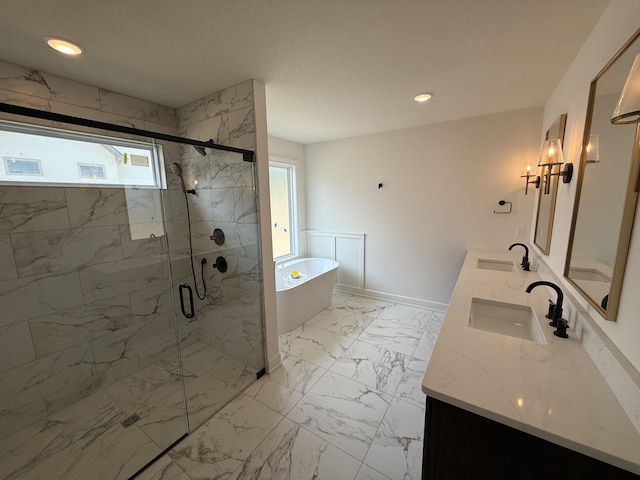 5915 Ivory Ln, Columbia, MO 65201 - bathroom featuring plenty of natural light, a freestanding tub, double vanity, a marble finish shower, and recessed lighting