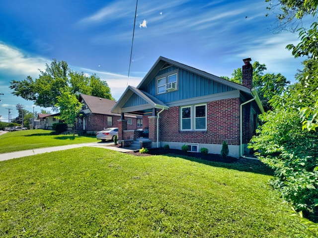 1008 W Broadway, Columbia, MO 65203 - bungalow-style house with brick siding, a chimney, a front lawn, board and batten siding, and cooling unit