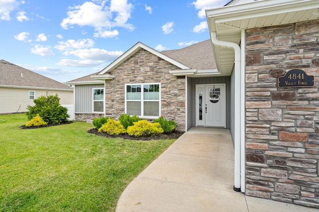 4841 Valley Forge Cir, Ashland, MO 65010 - doorway to property featuring stone siding, a yard, board and batten siding, and a shingled roof