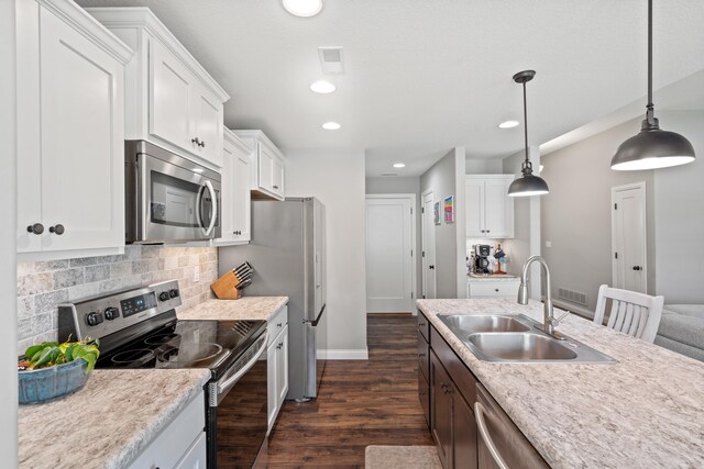 4841 Valley Forge Cir, Ashland, MO 65010 - kitchen with appliances with stainless steel finishes, a sink, dark wood-type flooring, baseboards, and light countertops